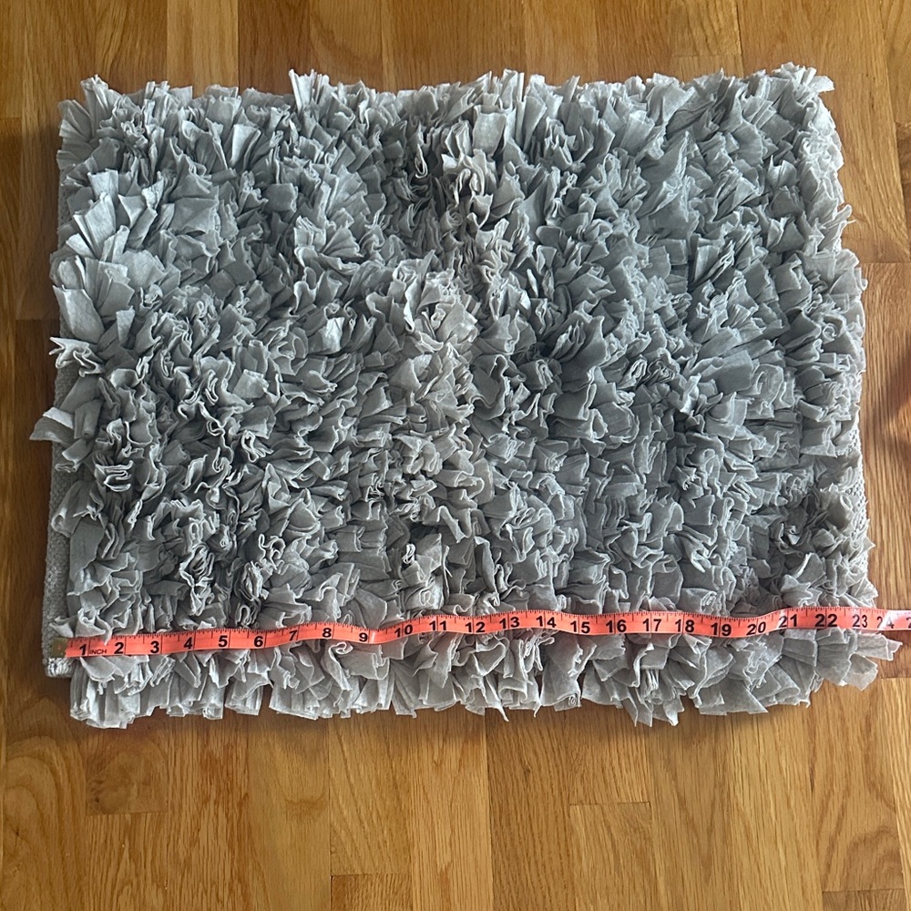 Bathroom rug in light grayish/taupe in color